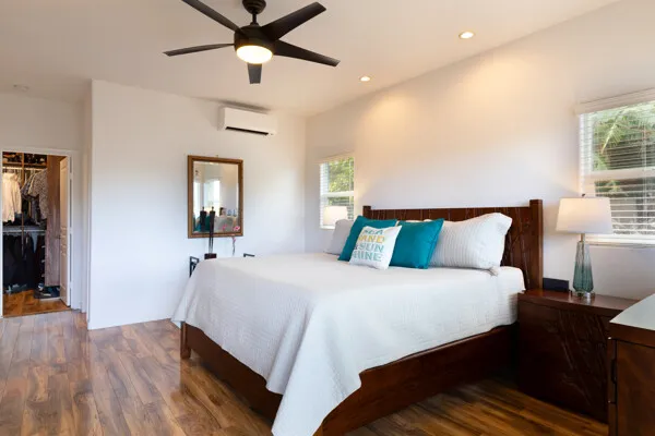 a bedroom with a bed and wooden floor