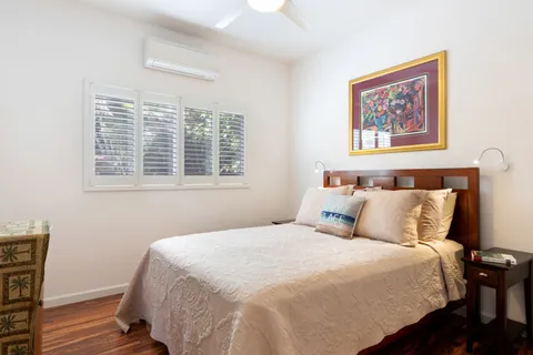 a bedroom with a large bed and a window