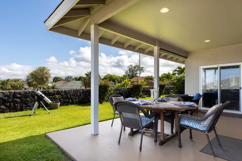 a view of a patio with a table chairs and a backyard