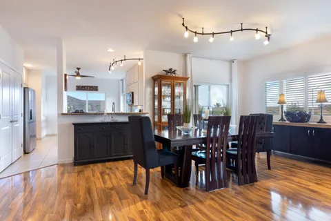a view of dining table a large window and entryway