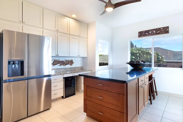 a kitchen with stainless steel appliances granite countertop a refrigerator and a stove
