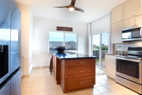 a kitchen with stainless steel appliances granite countertop a stove and a refrigerator
