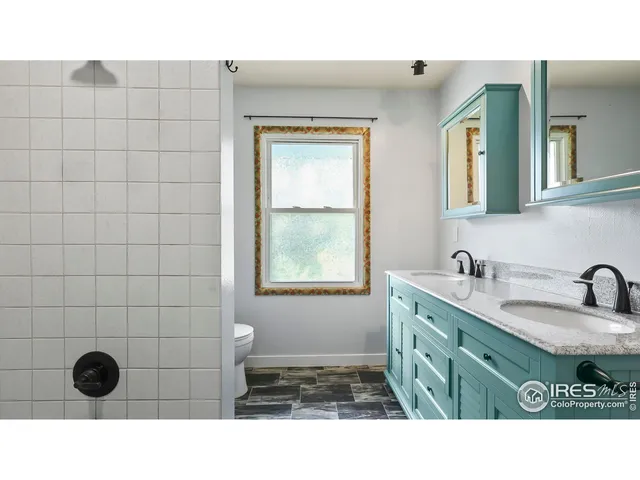 a bathroom with a sink double vanity and a mirror