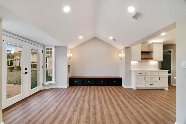 a large kitchen with stainless steel appliances kitchen island granite countertop a large counter top and a stove top oven