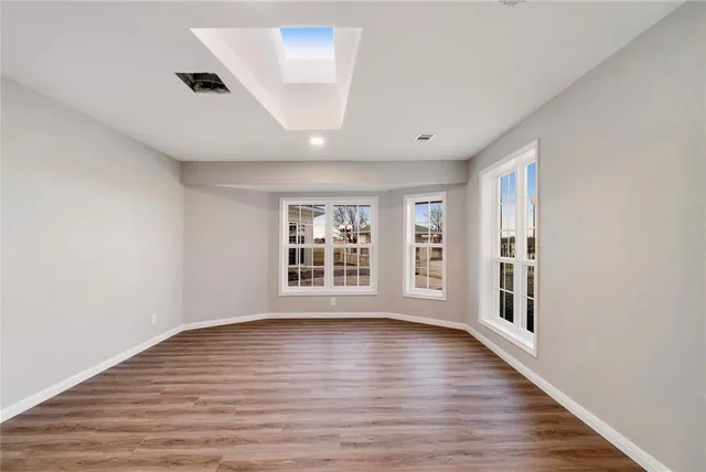 a view of an empty room with kitchen