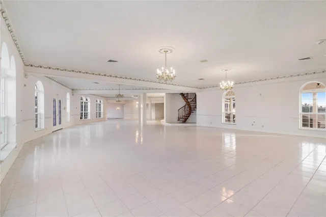 a view of an empty room with chandelier