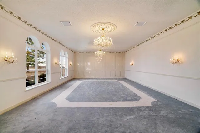 an empty room with windows and entrance