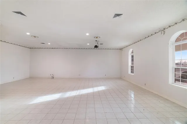 a spacious bathroom with a toilet sink and mirror