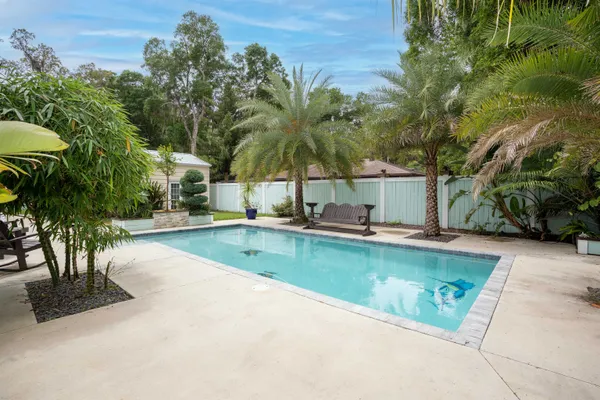 a view of a house with pool and sitting area