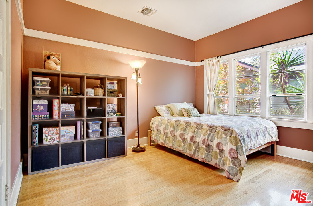 1204 Bresee Avenue Pasadena, CA 91104 - Photo 16 of 31 a spacious bedroom with a large bed and a book shelf
