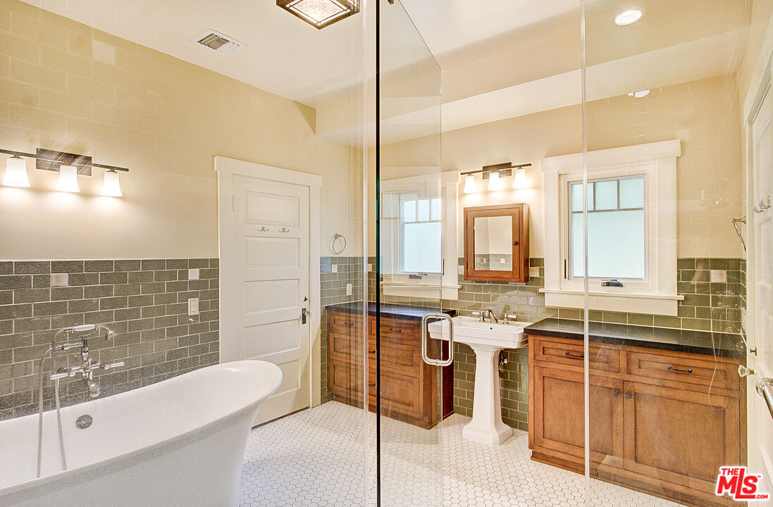 1204 Bresee Avenue Pasadena, CA 91104 - Photo 22 of 31 a large bathroom with a glass door shower and sink