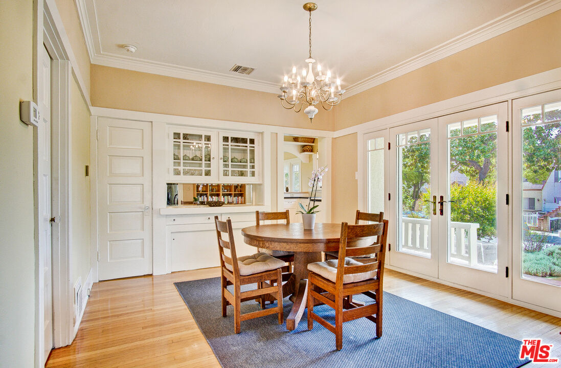 1204 Bresee Avenue Pasadena, CA 91104 - Photo 9 of 31 a view of a dining room with furniture a chandelier and wooden floor