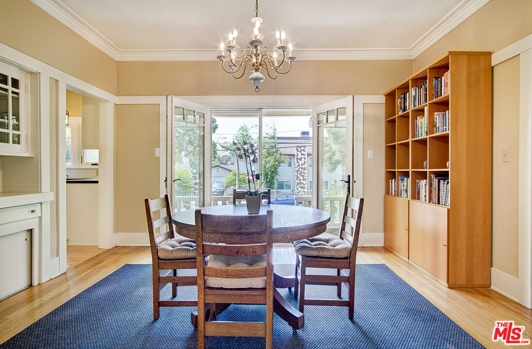 1204 Bresee Avenue Pasadena, CA 91104 - Photo 10 of 31 a dining room with furniture a chandelier and wooden floor