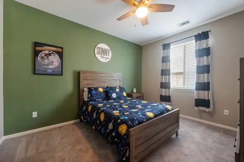 a bedroom with a bed and a chandelier