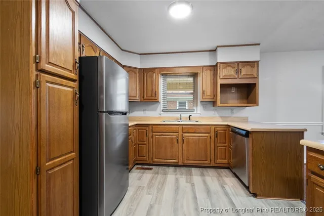 a kitchen with stainless steel appliances granite countertop a refrigerator and a sink