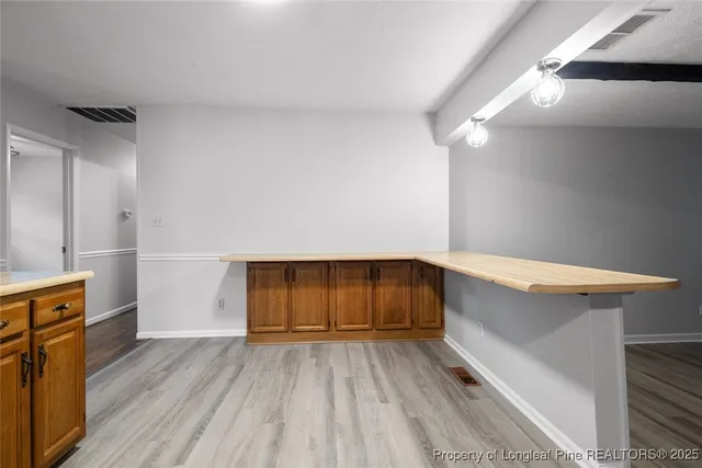 a view of kitchen with wooden floor and electronic appliances