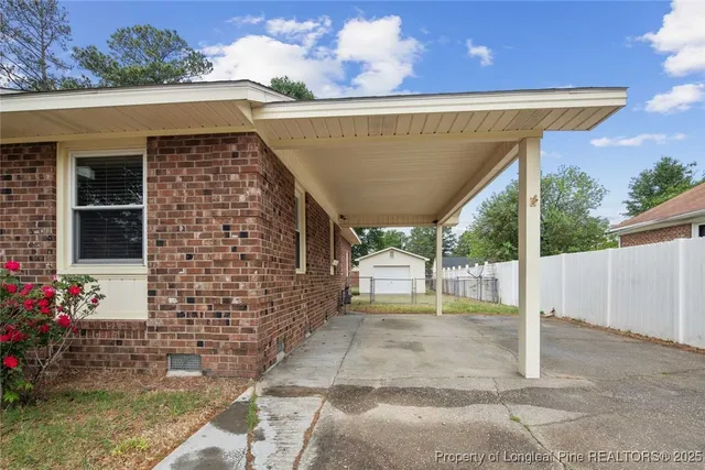 a view of a patio with table and chairs potted plants