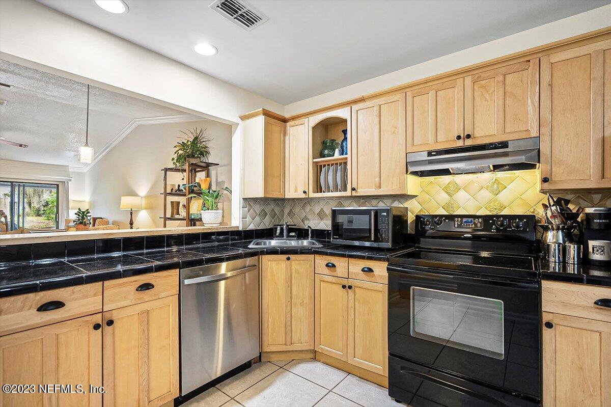 3801 Crown Point Road, Unit 3071 Jacksonville, FL 32257 - Photo 3 of 27 a kitchen with granite countertop white cabinets and stainless steel appliances