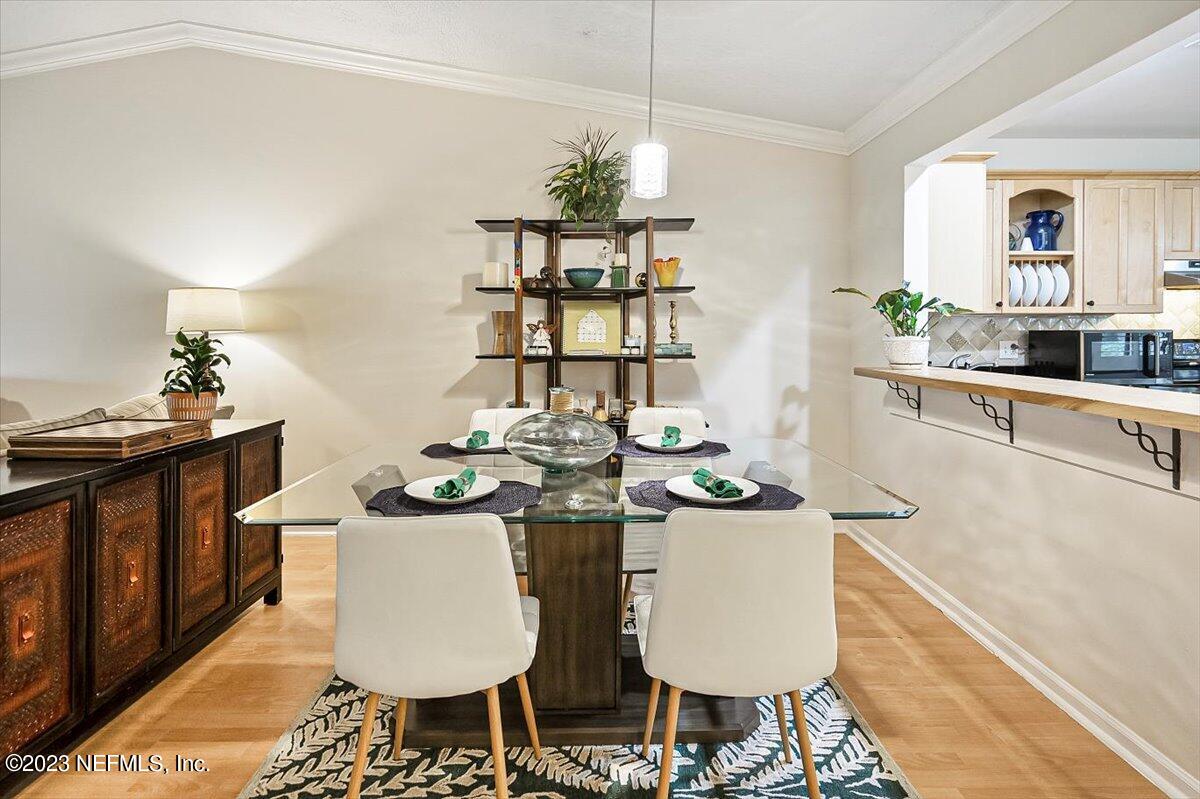 3801 Crown Point Road, Unit 3071 Jacksonville, FL 32257 - Photo 5 of 27 a kitchen with stainless steel appliances kitchen island granite countertop a table and chairs in it