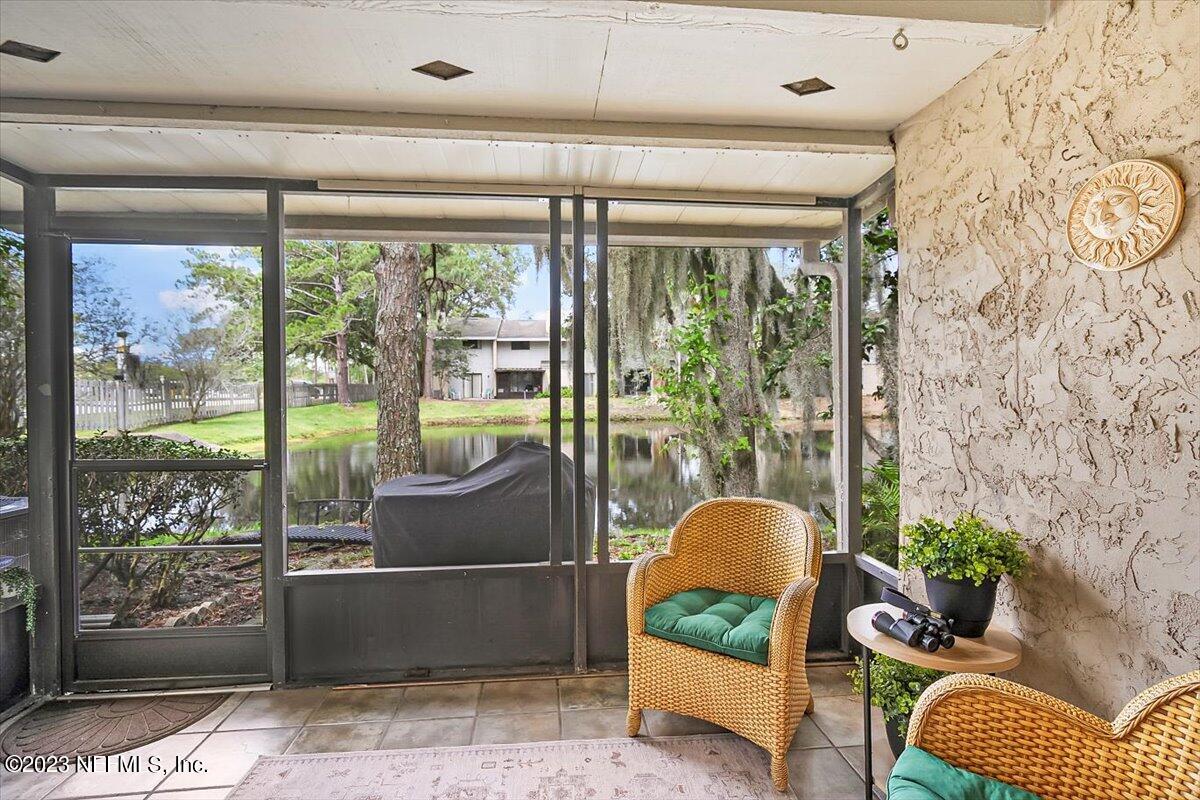 3801 Crown Point Road, Unit 3071 Jacksonville, FL 32257 - Photo 8 of 27 a living room with furniture and a floor to ceiling window
