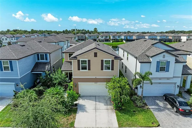 a aerial view of a house with a yard and potted plants