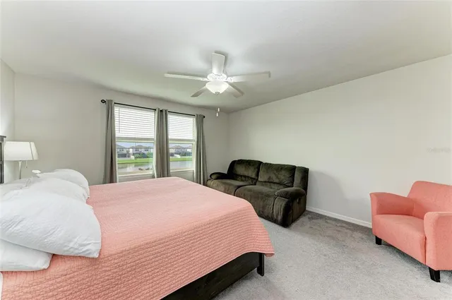 a bedroom with a bed and a couch