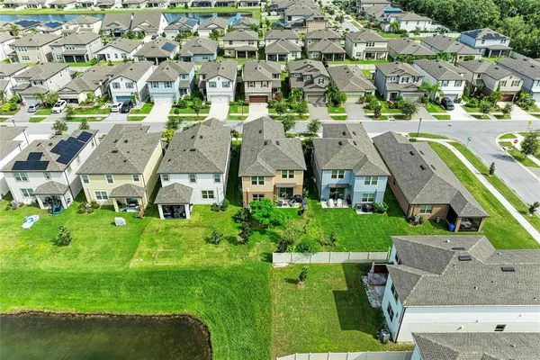 an aerial view of multiple houses with yard