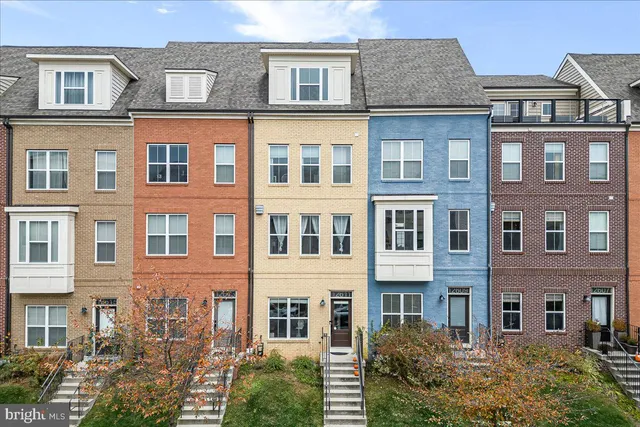 a front view of a residential apartment building with a yard