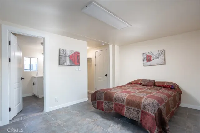 a bedroom with a bed and painting on the wall