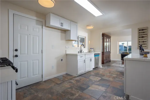 a kitchen with cabinets and window