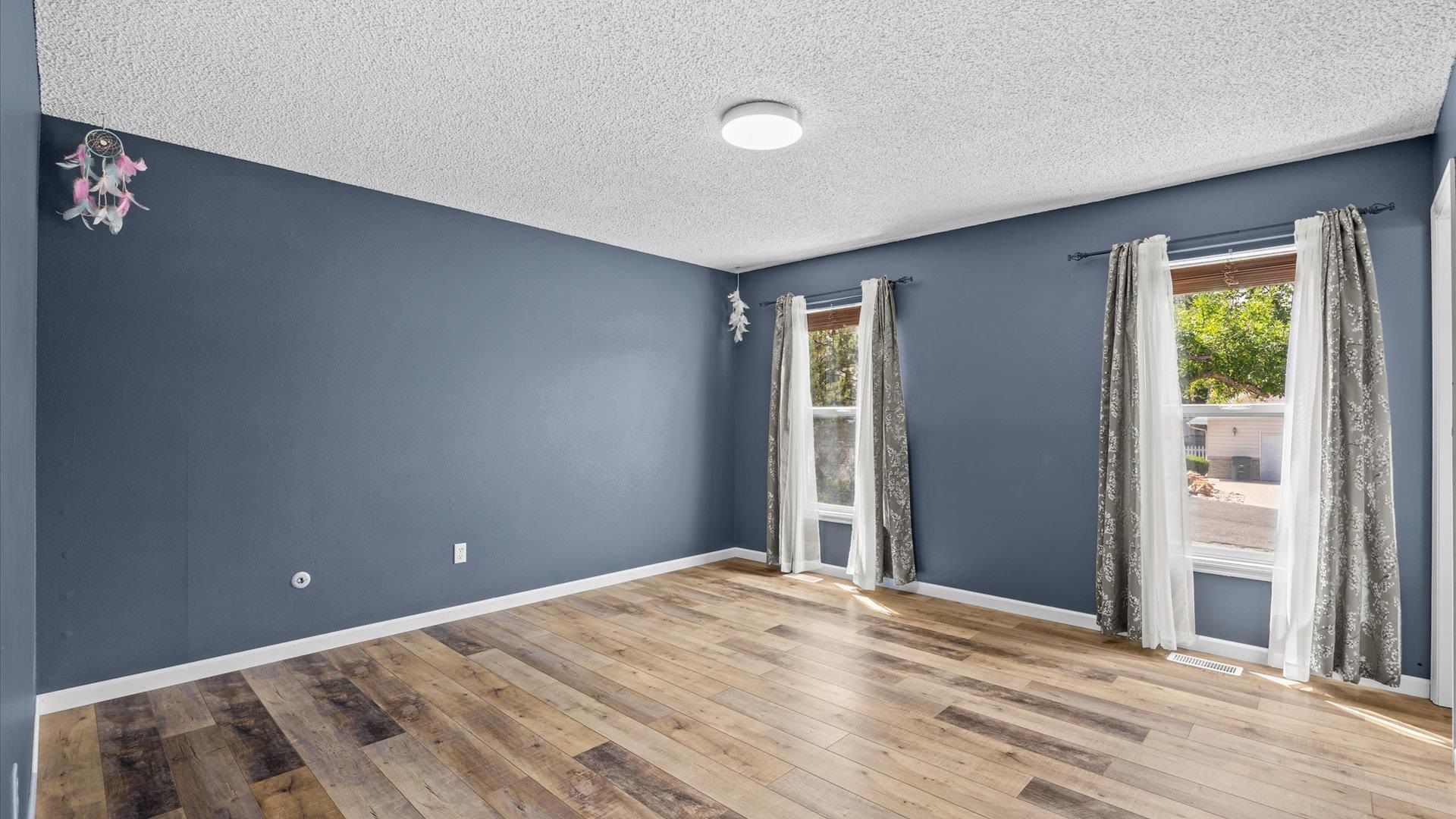 386 Ridge Cir Drive Grand Junction, CO 81507 - Photo 15 of 29 a view of a bedroom with wooden floor and a window