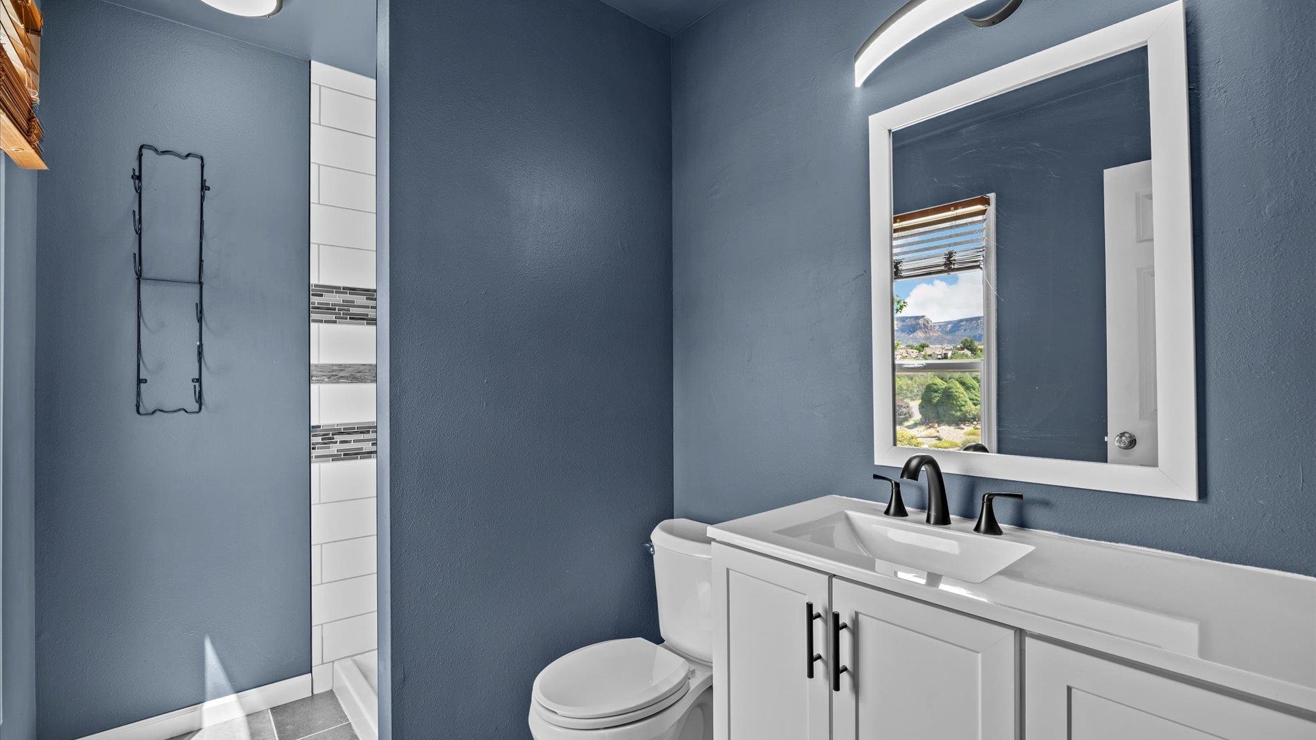 386 Ridge Cir Drive Grand Junction, CO 81507 - Photo 17 of 29 a bathroom with a sink toilet and window