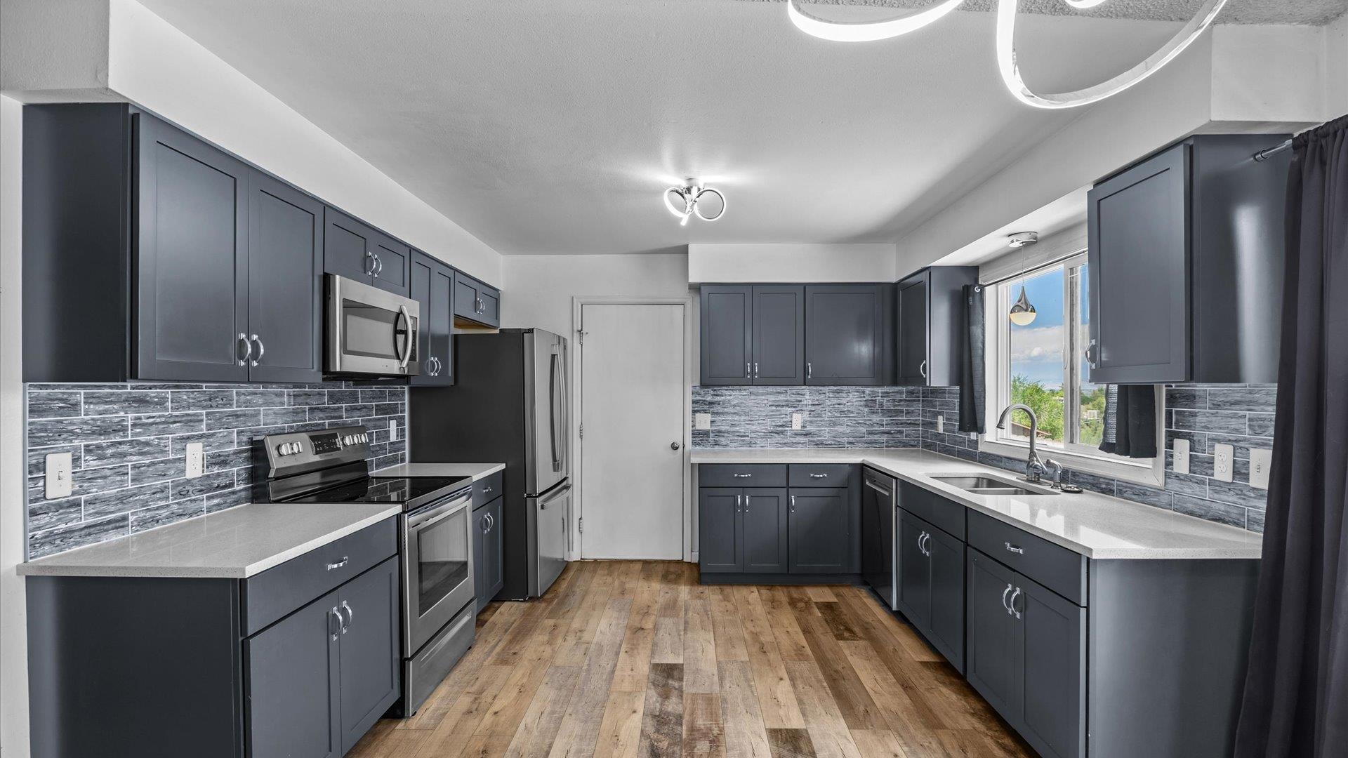 386 Ridge Cir Drive Grand Junction, CO 81507 - Photo 10 of 29 a kitchen with stainless steel appliances granite countertop a sink stove cabinets and refrigerator