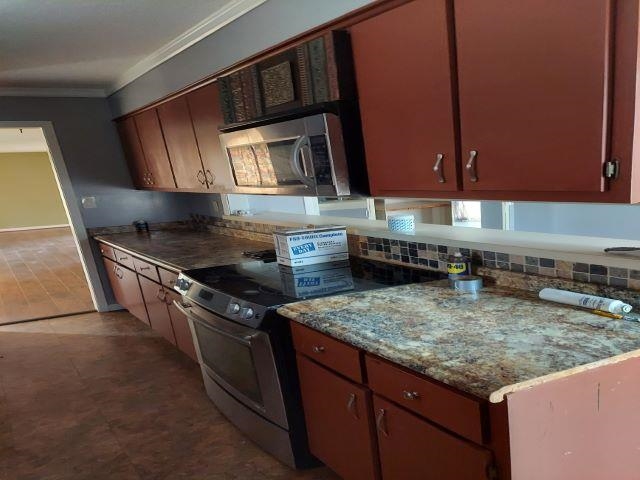3615 County Gates Road Memphis, TN 38119 - Photo 6 of 7 a kitchen with stainless steel appliances granite countertop a stove a sink and a microwave