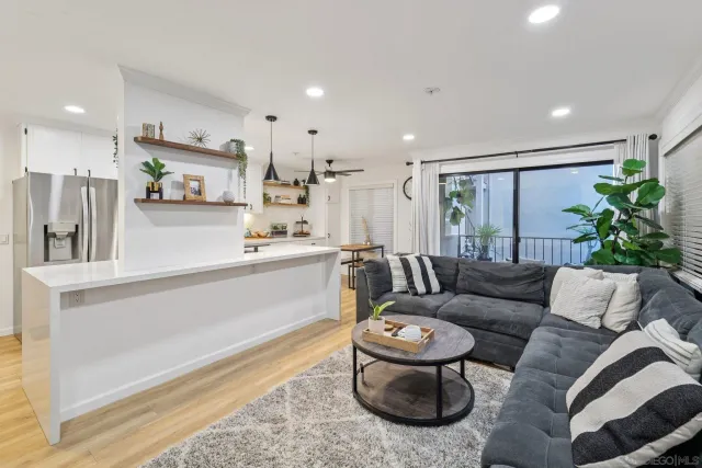 a kitchen with kitchen island a white counter top space cabinets and stainless steel appliances
