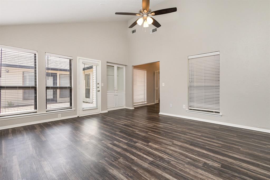 3104 Cross Bend Road Plano, TX 75023 - Photo 12 of 28 a view of an empty room with wooden floor and a window