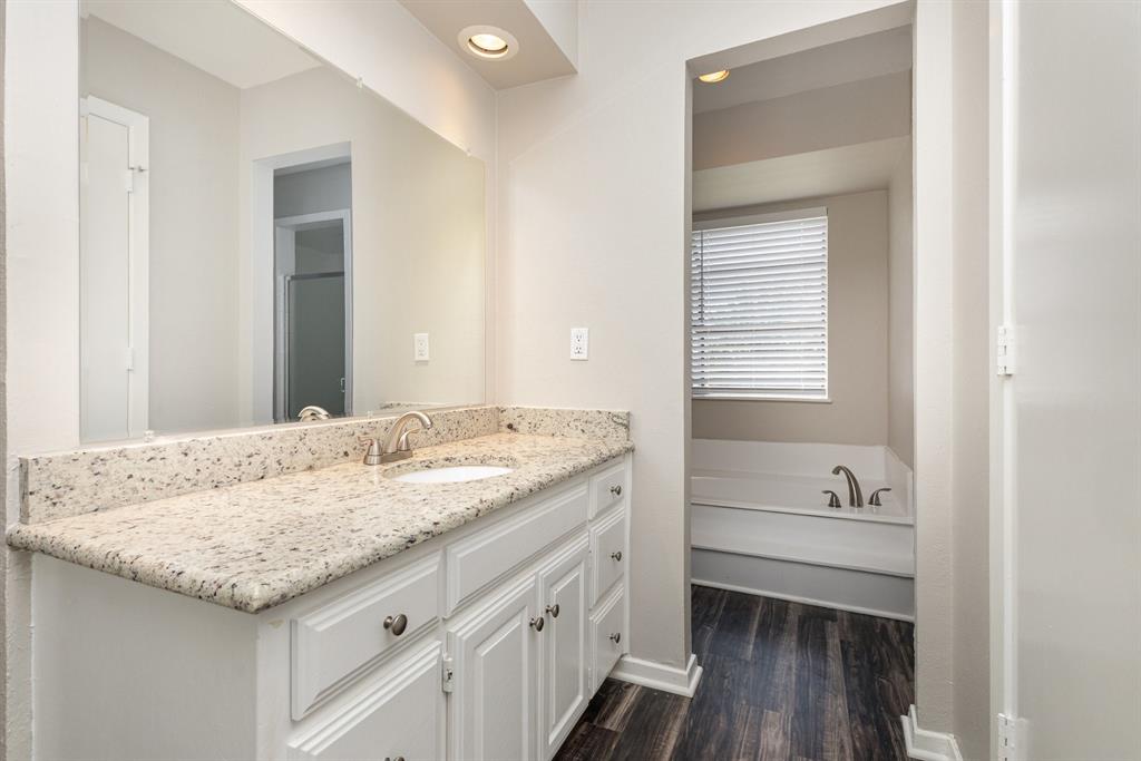 3104 Cross Bend Road Plano, TX 75023 - Photo 15 of 28 a bathroom with a granite countertop sink and a window