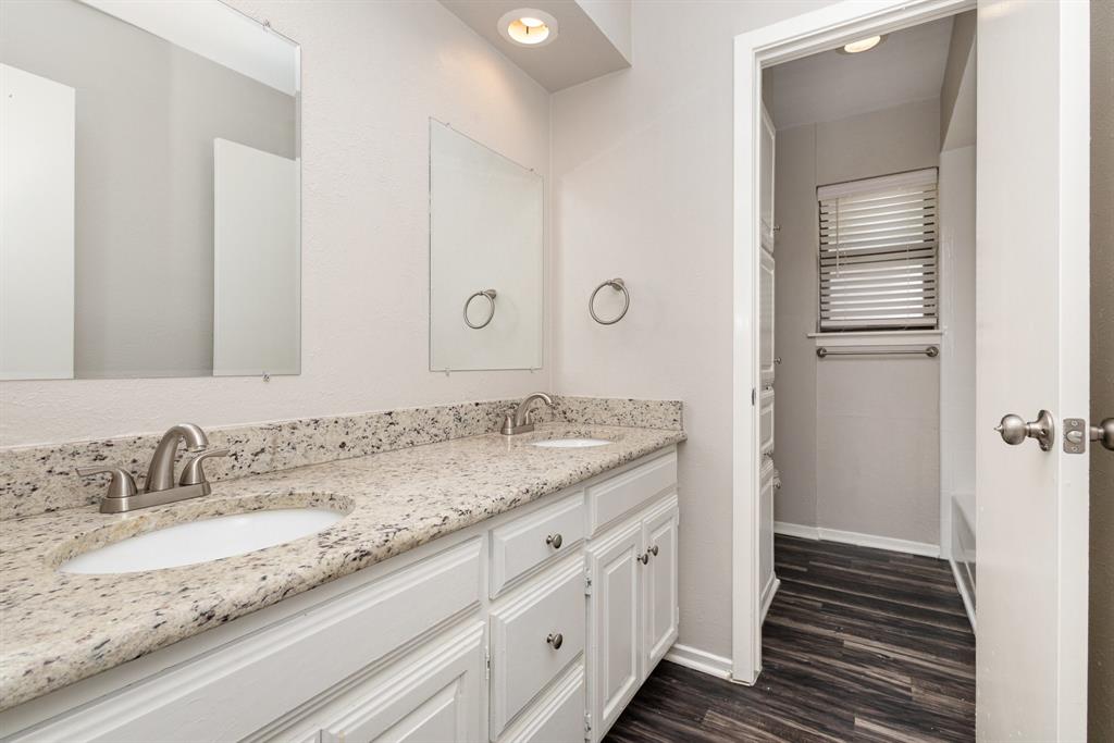 3104 Cross Bend Road Plano, TX 75023 - Photo 21 of 28 a bathroom with a granite countertop sink and a mirror