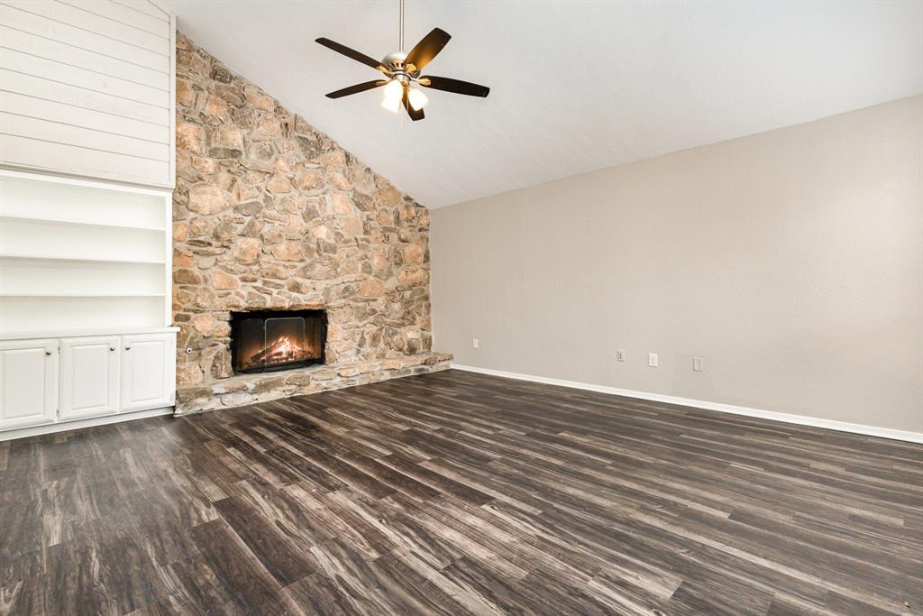 3104 Cross Bend Road Plano, TX 75023 - Photo 3 of 28 a view of empty room with wooden floor and fireplace
