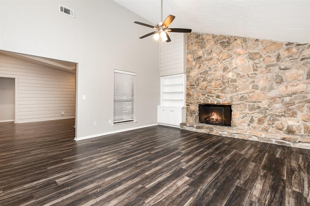 3104 Cross Bend Road Plano, TX 75023 - Photo 5 of 28 a view of empty room with wooden floor and fireplace