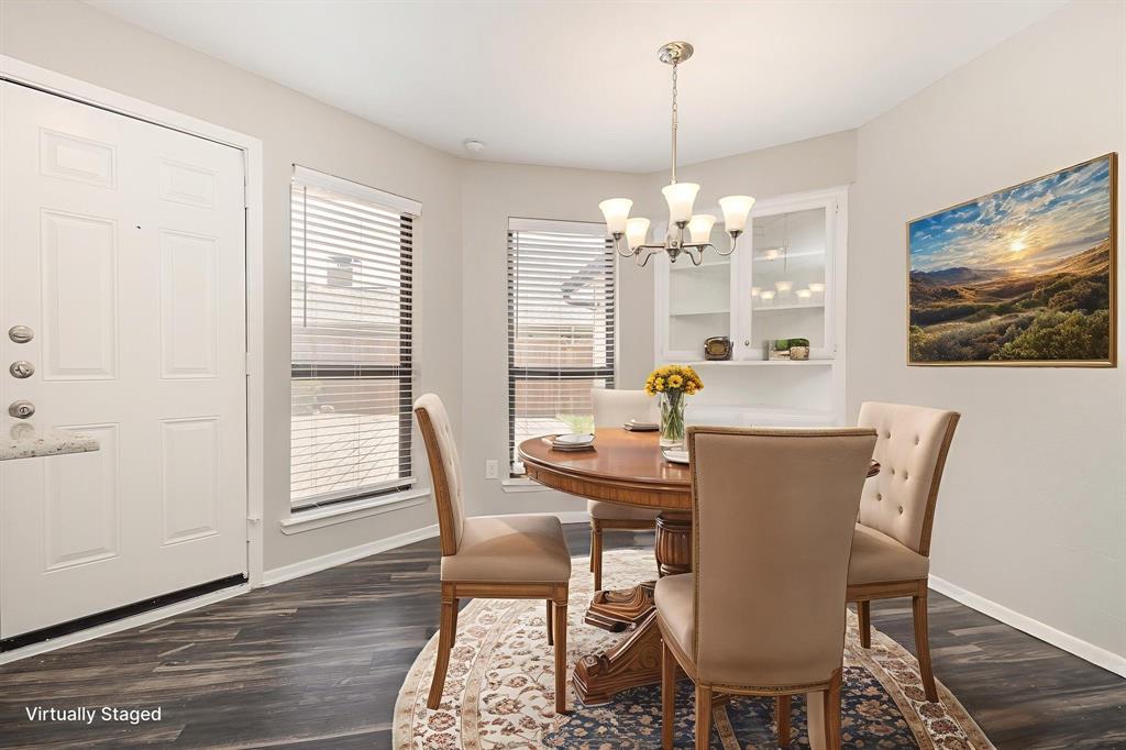 3104 Cross Bend Road Plano, TX 75023 - Photo 7 of 28 a view of a dining room with furniture wooden floor and chandelier