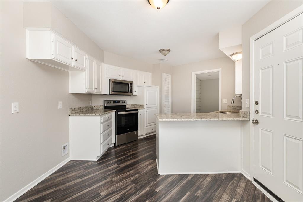 3104 Cross Bend Road Plano, TX 75023 - Photo 8 of 28 a kitchen with granite countertop white cabinets and stainless steel appliances