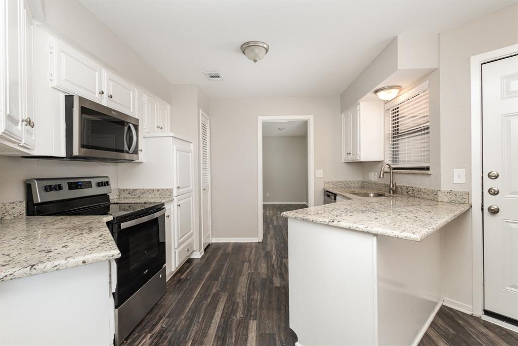 3104 Cross Bend Road Plano, TX 75023 - Photo 9 of 28 a kitchen with a sink a microwave a stove and refrigerator