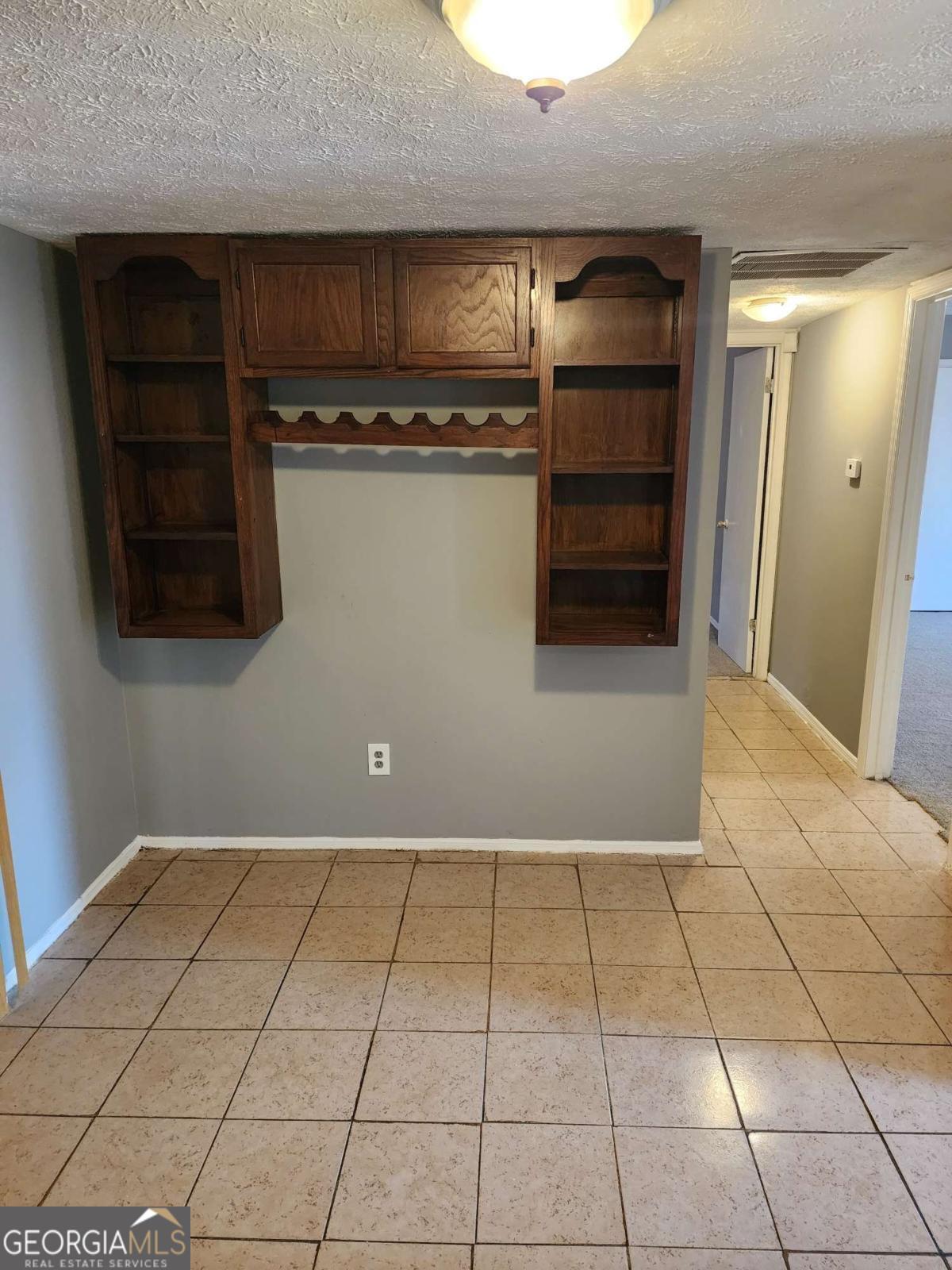 128 Cardinal Lane Jonesboro, GA 30238 - Photo 7 of 16 a view of a refrigerator in kitchen and an empty room