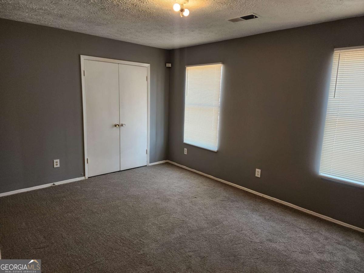 128 Cardinal Lane Jonesboro, GA 30238 - Photo 8 of 16 an empty room with windows and closet