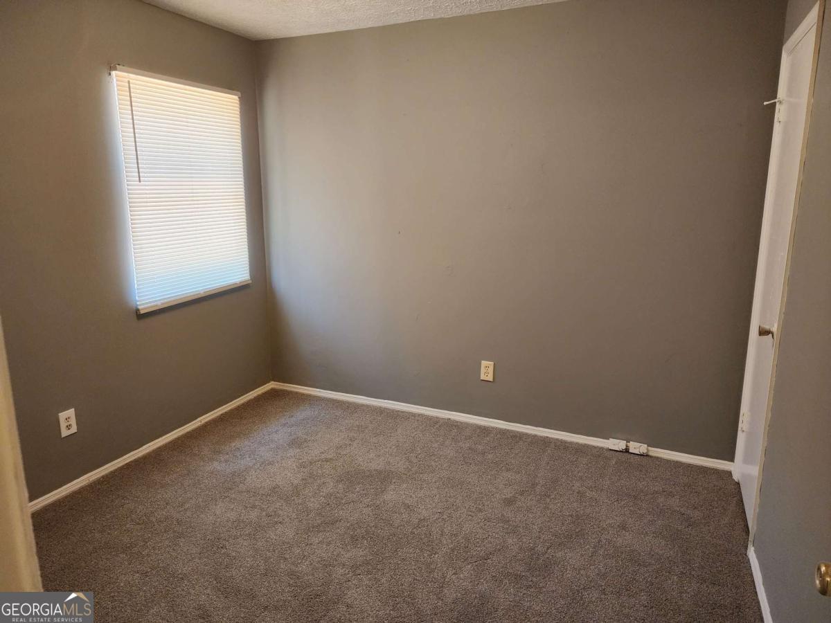 128 Cardinal Lane Jonesboro, GA 30238 - Photo 10 of 16 an empty room with a window