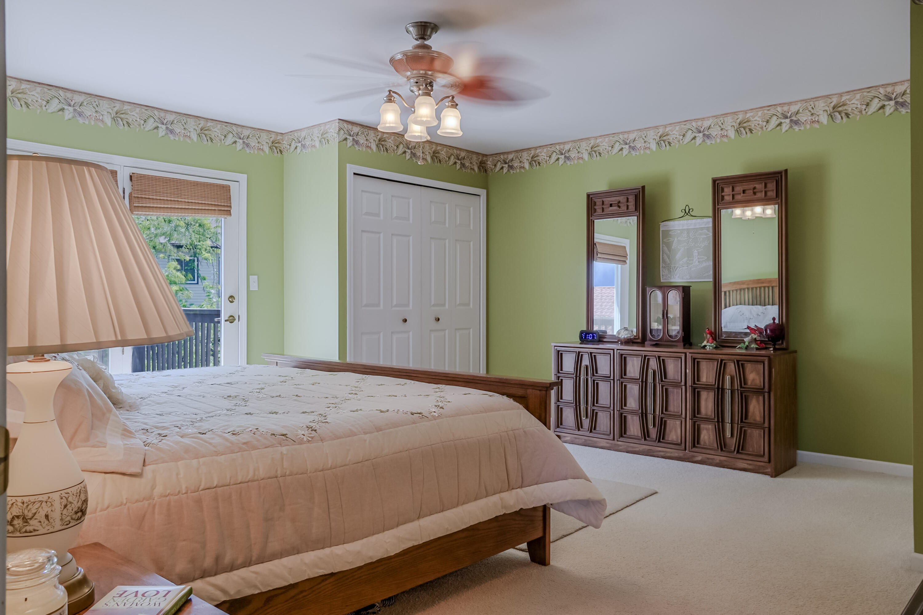 5065 Spinnaker Lane, Unit D Crown Point, IN 46307 - Photo 18 of 42 a bedroom with a bed and a chandelier