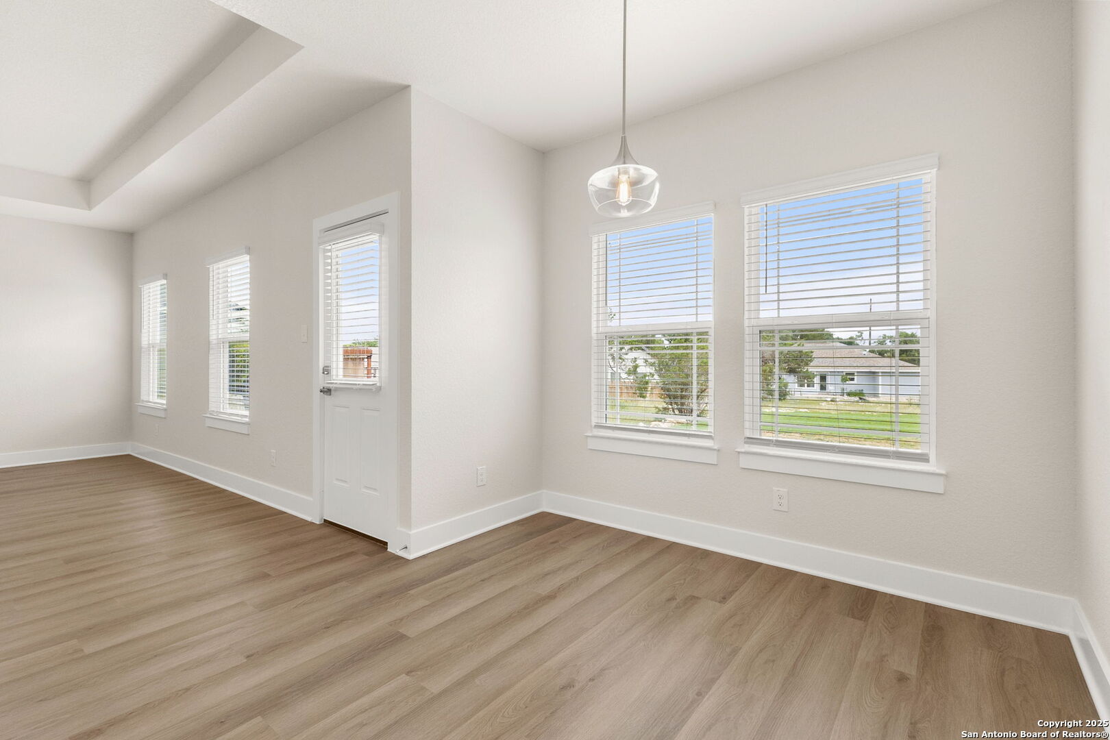 952 Rimrock Cove Spring Branch, TX 78070 - Photo 13 of 39 an empty room with wooden floor and windows