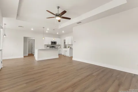 a view of a kitchen with a sink and wooden floor