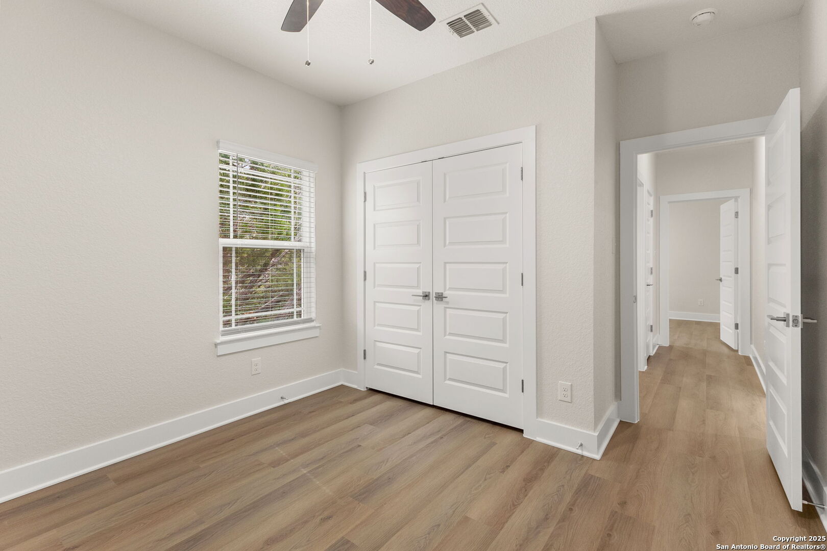952 Rimrock Cove Spring Branch, TX 78070 - Photo 22 of 39 an empty room with wooden floor and windows